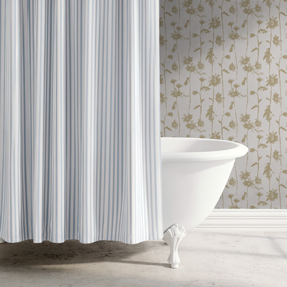Beige floral wallpaper in bathroom with white clawfoot tub and striped shower curtain.