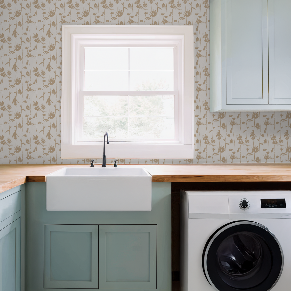 Beige floral wallpaper in a laundry room with sink and washer.