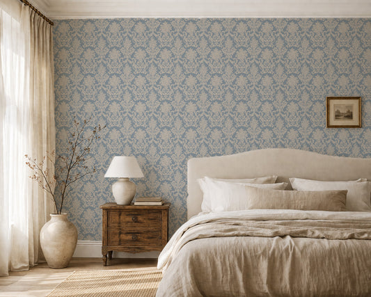 Elegant blue and tan damask wallpaper in a cozy bedroom setting.