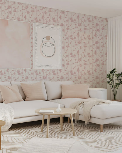 Blush pink floral wallpaper in modern living room with cream sofa and decor.
