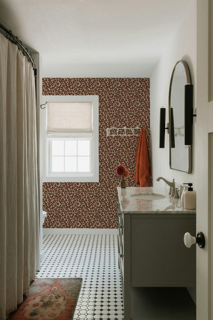 Brown leopard print wallpaper in a modern bathroom with white fixtures and decor.