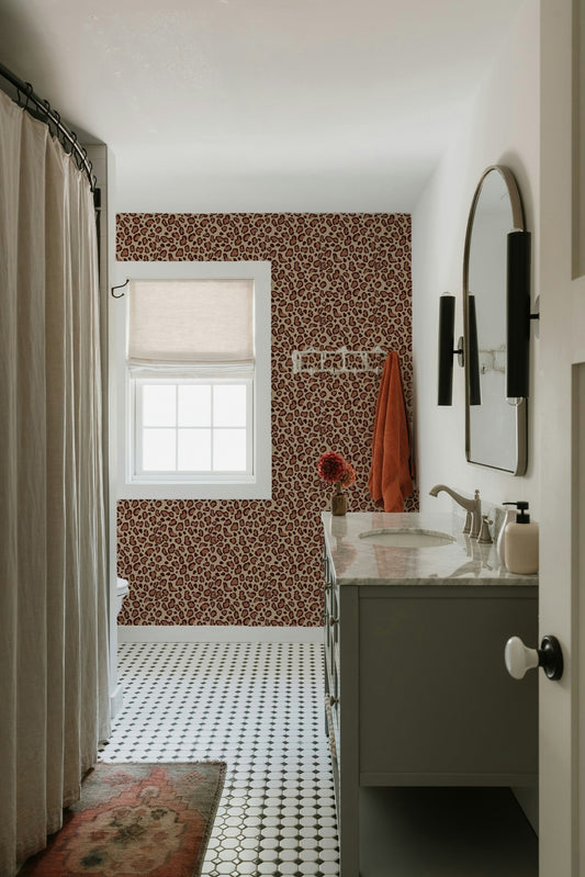 Brown leopard print wallpaper in a modern bathroom with white fixtures and decor.