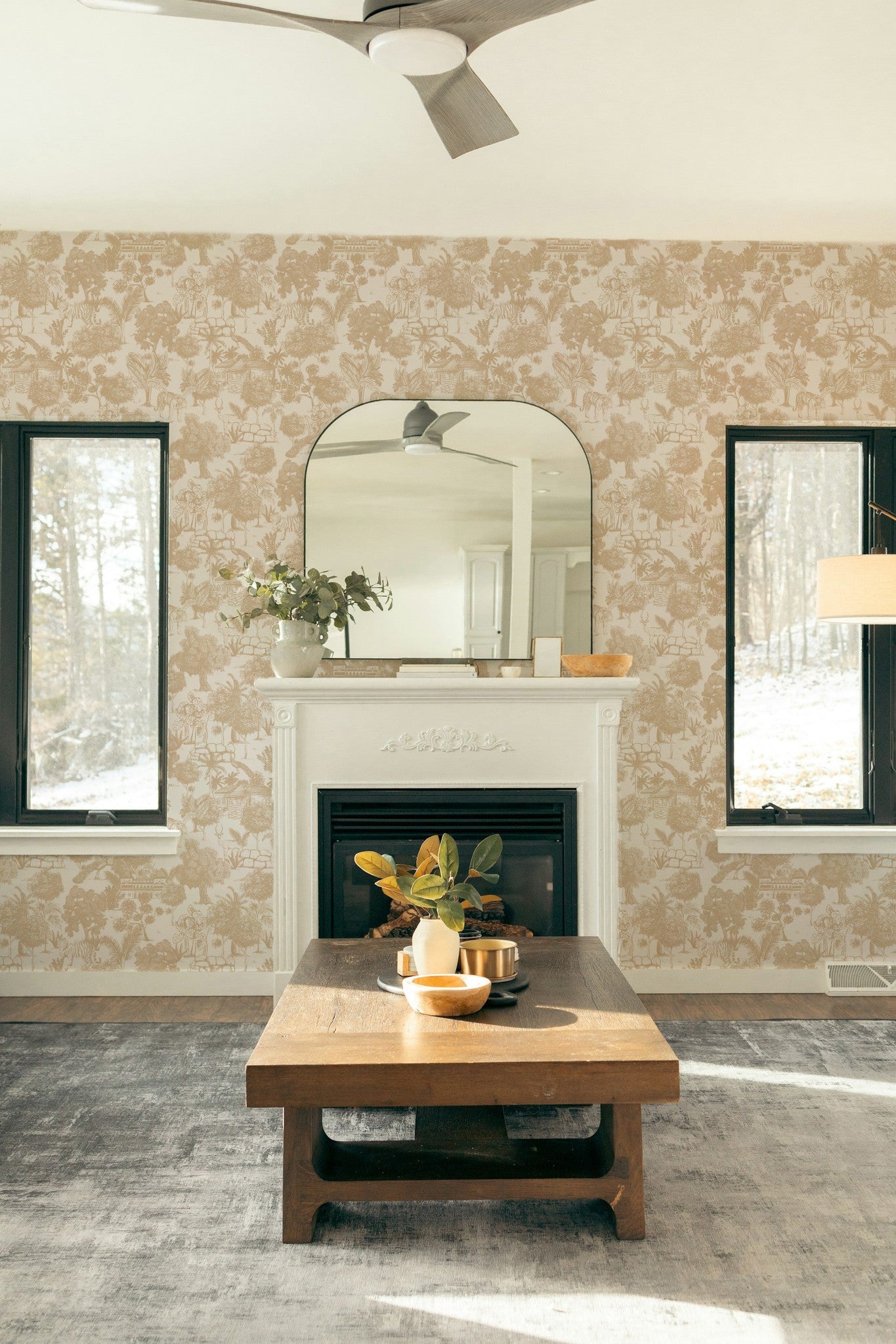Cream jungle toile wallpaper with tigers and trees in a cozy living room setting.