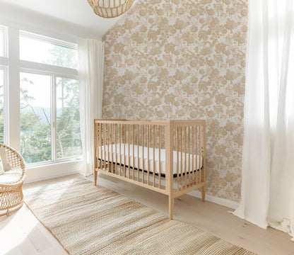 Cream jungle toile wallpaper with tigers and deer in a bright nursery with a crib.