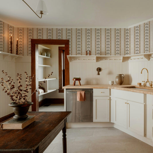 Cream and mustard floral stripe wallpaper in rustic kitchen setting.