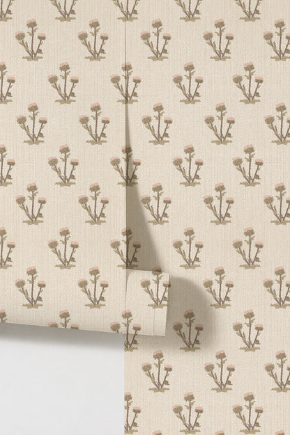 Cream wallpaper with pink thistle block print pattern and textured finish.