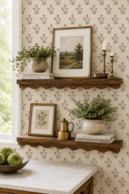 Cream and pink thistle wallpaper with wooden shelves and decor in a cozy room.