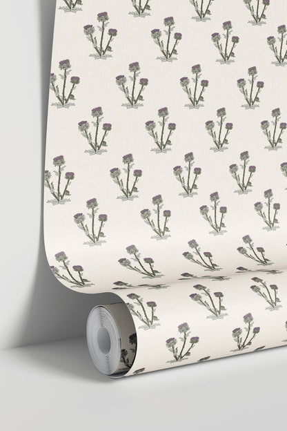 Cream wallpaper with purple and green thistle pattern in a roll.