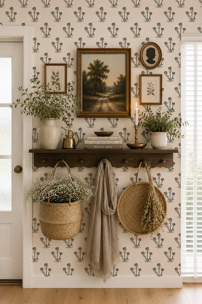 Cream wallpaper with purple and green thistle pattern in vintage room setting with shelf and decor.