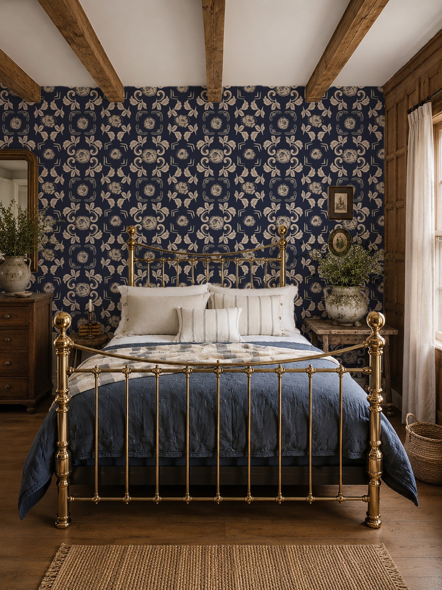 Dark blue floral wallpaper in vintage bedroom with brass bed and wooden beams.