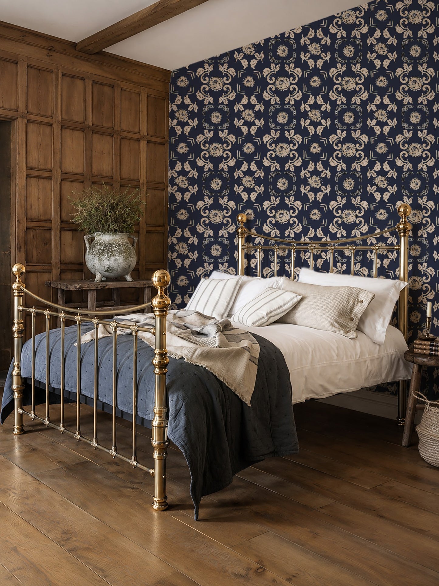 Dark blue floral wallpaper with ornate motifs in a vintage bedroom setting.