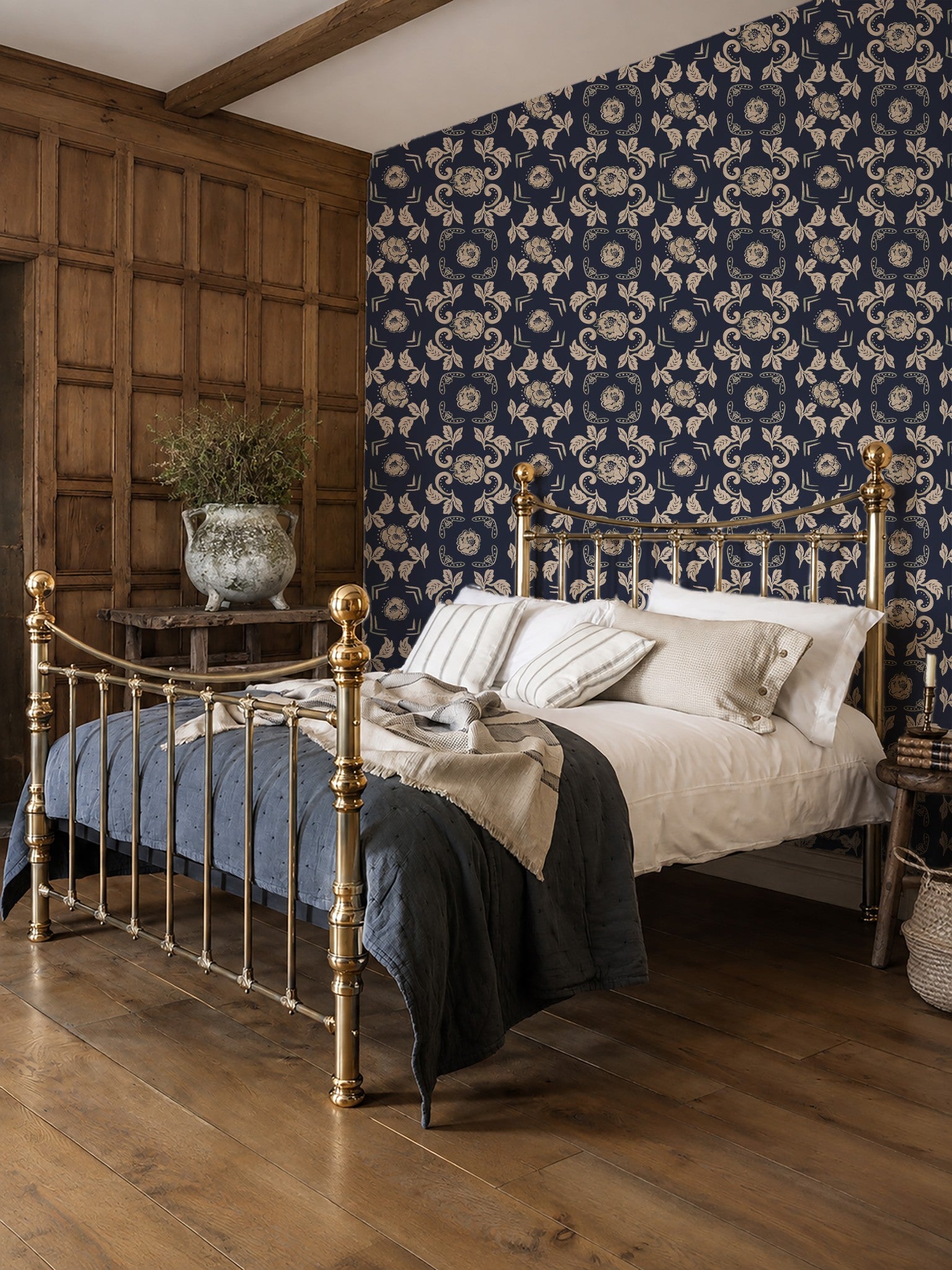 Dark blue floral wallpaper with ornate motifs in a vintage bedroom setting.
