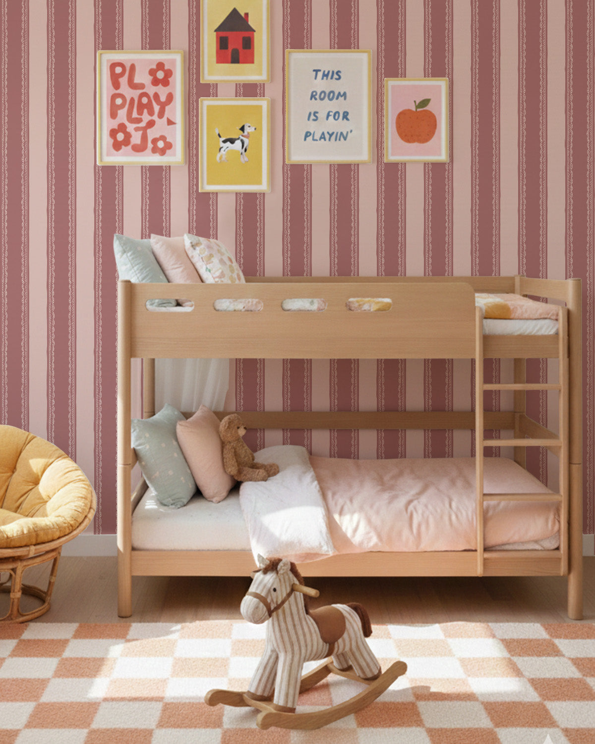 Dark pink striped wallpaper with lace detail in a vintage room with yellow chair and decor.