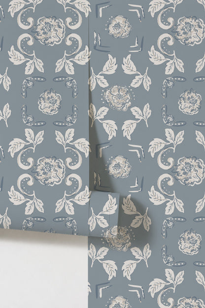 Dusty blue floral wallpaper with white and gold motifs, elegant vintage style.