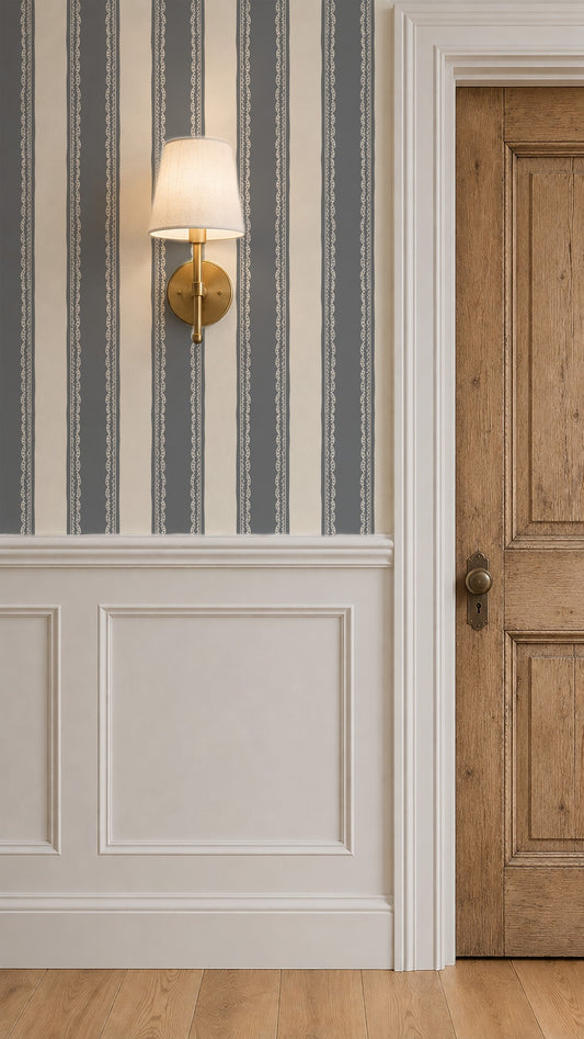 Dusty blue and cream striped wallpaper with lace detailing in elegant room with wood door.