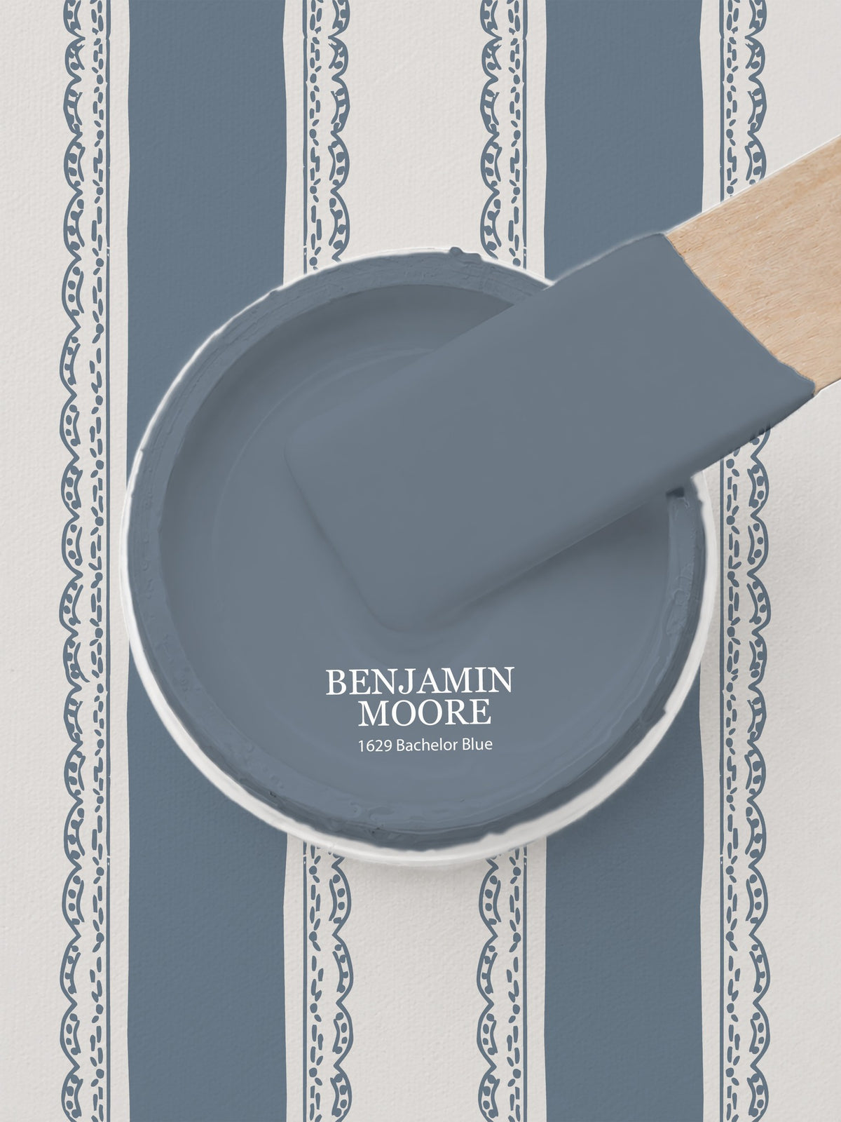 Dusty blue striped wallpaper with lace borders and paint sample.
