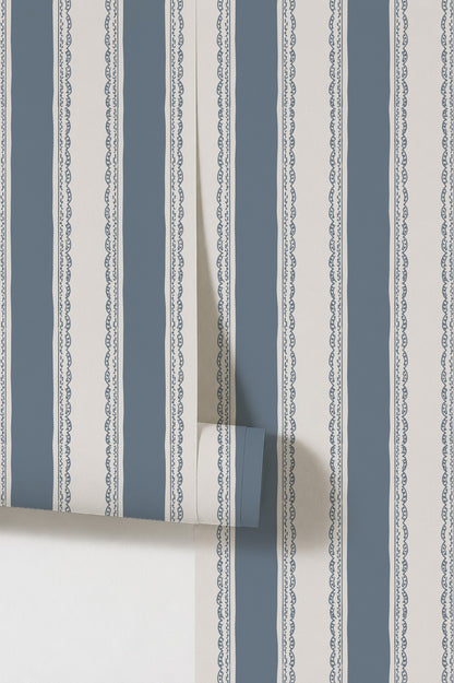 Dusty blue striped wallpaper with lace borders in a classic design.