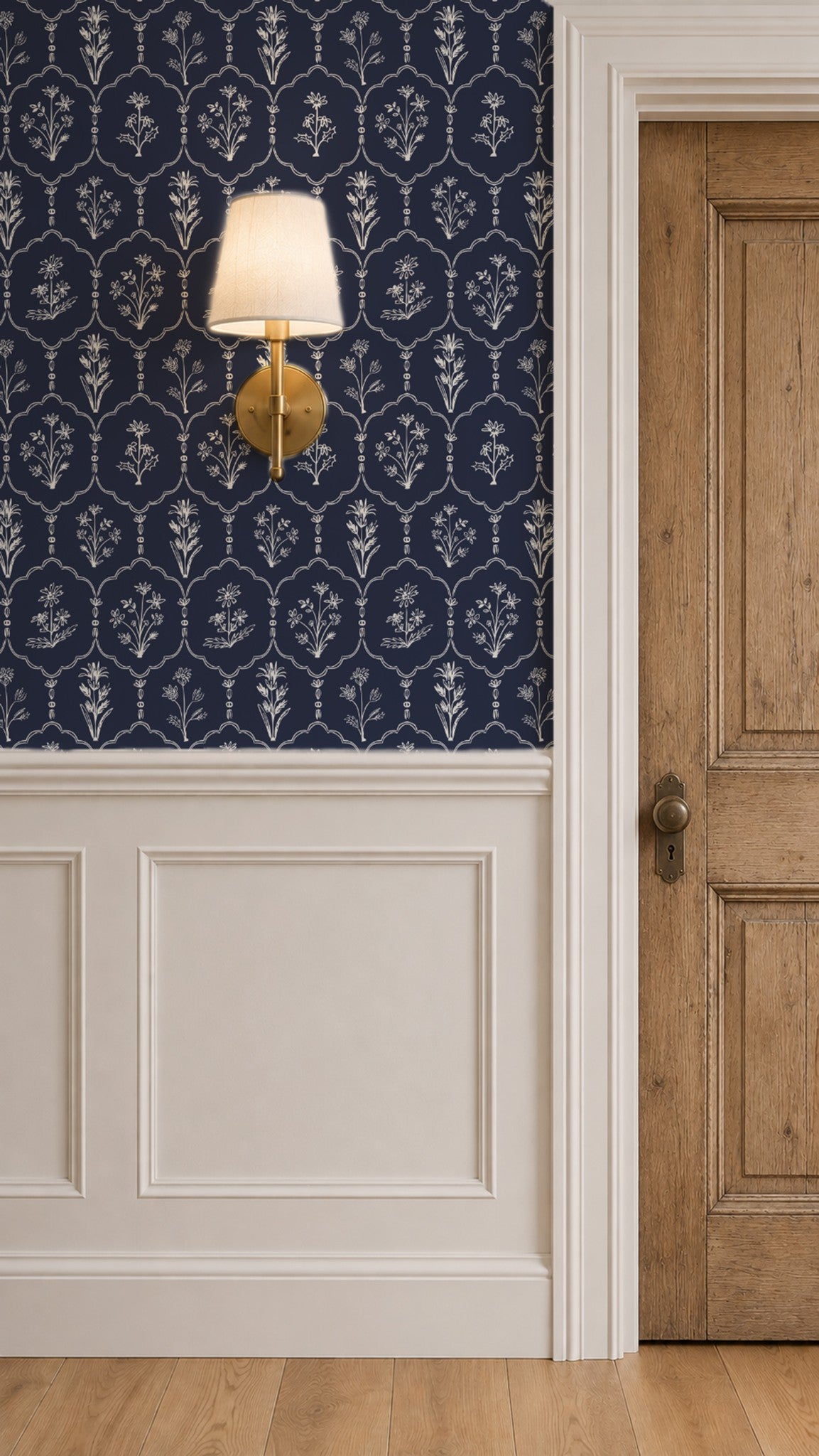 Floral Trellis Blue wallpaper with white motifs in classic room with wall sconce.
