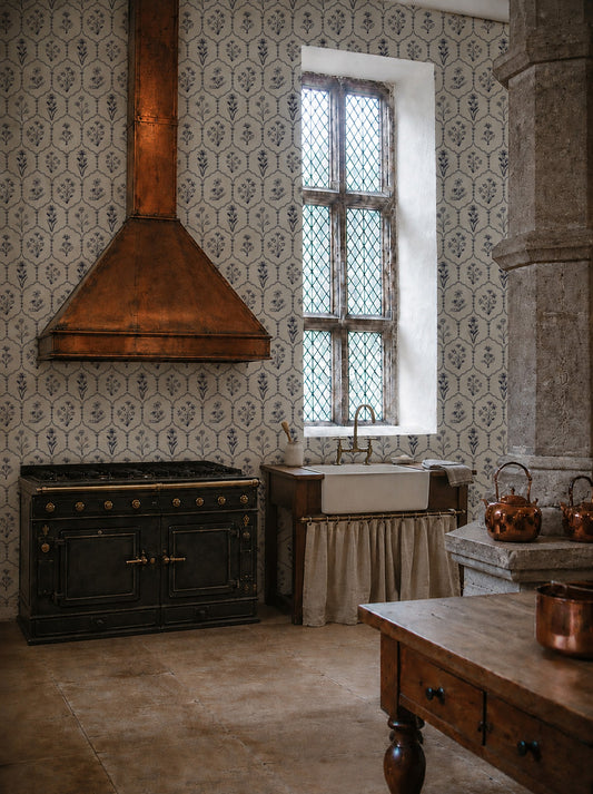 Floral trellis navy on white wallpaper in rustic kitchen with copper accents.