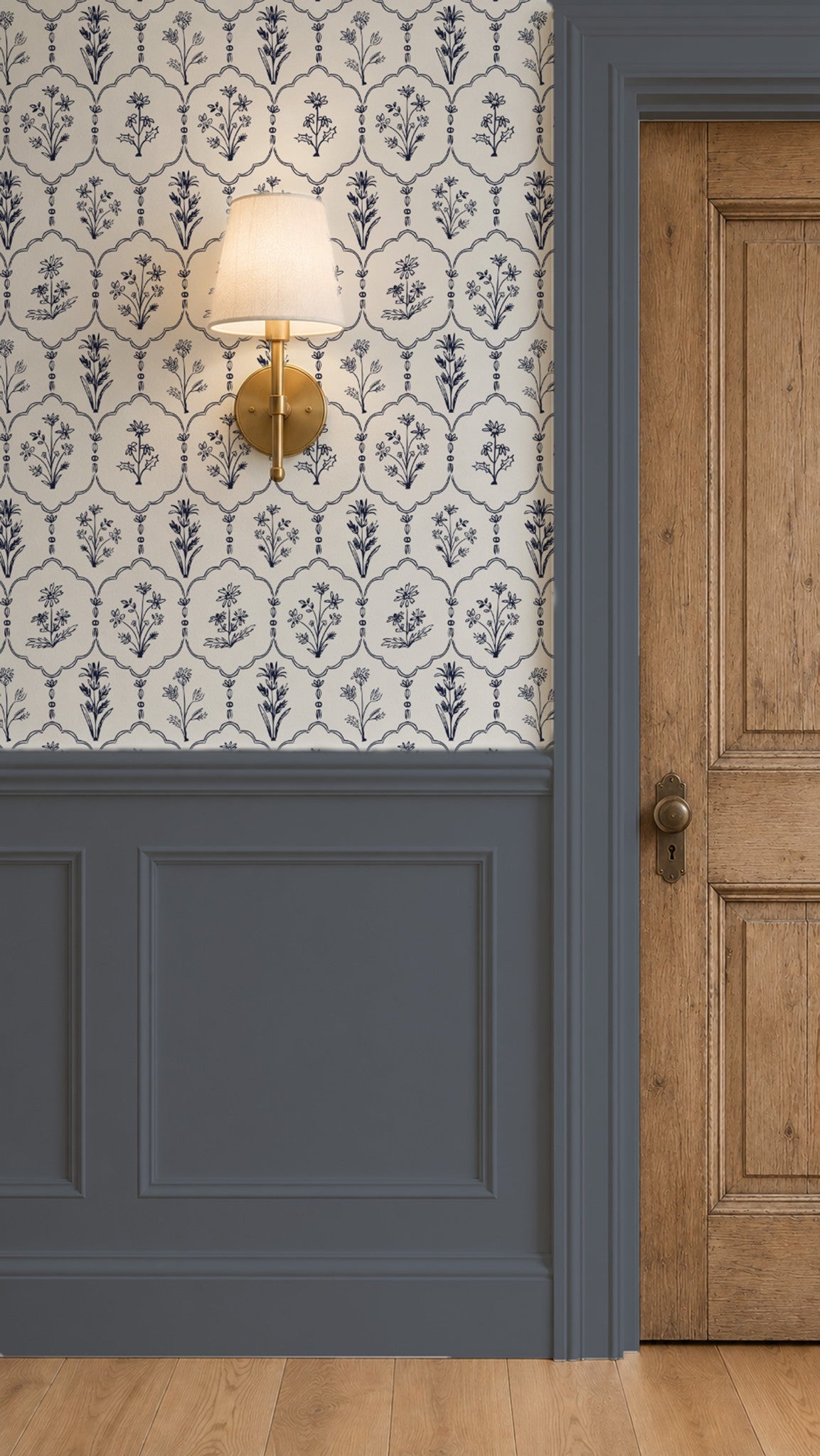 Floral trellis wallpaper with navy blue motifs on white background in elegant room with wooden door.