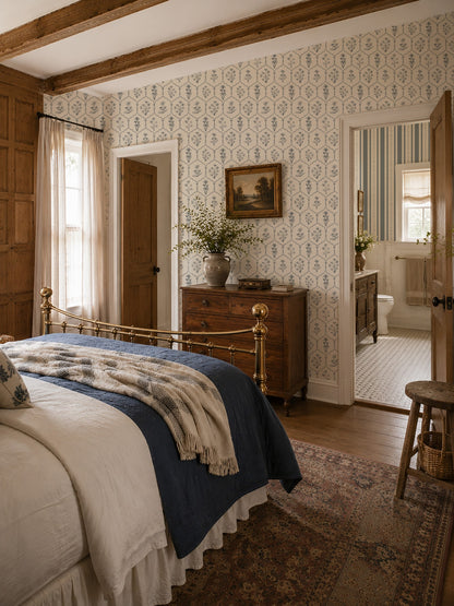 Floral trellis white wallpaper in vintage bedroom with wooden beams and brass bed.