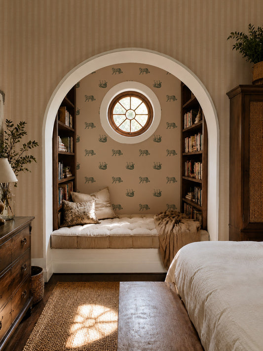 Cozy bedroom with green tiger motif wallpaper, arched reading nook, and warm decor.