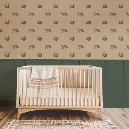 Green tiger pattern wallpaper in nursery with wooden crib and green wainscoting.