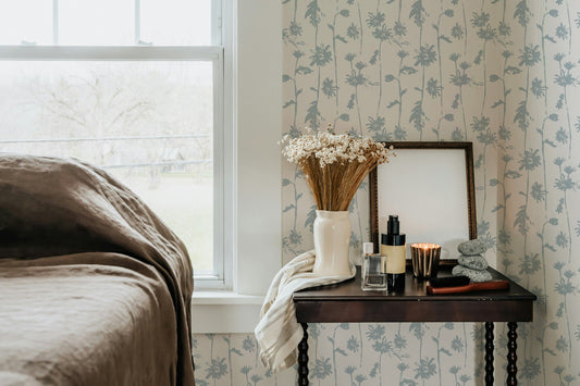 Jocelyn Blue & Cream floral wallpaper in cozy bedroom with rustic decor.