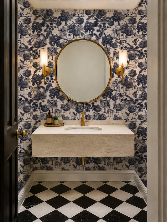 Jungle Toile Blue wallpaper in a bathroom with round mirror and gold fixtures.