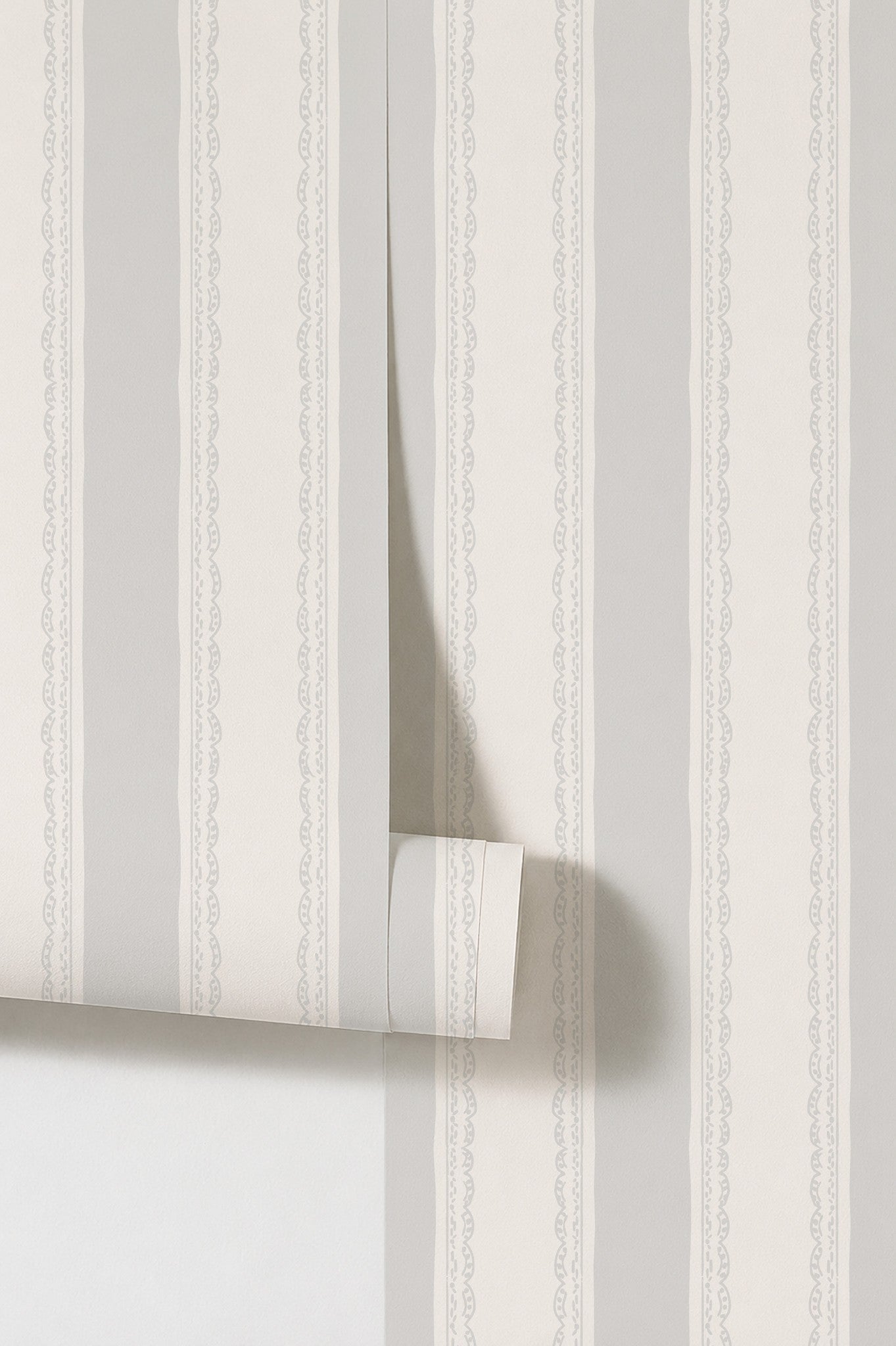 Lacey Stripe Light Blue wallpaper with soft grey stripes and lace borders.