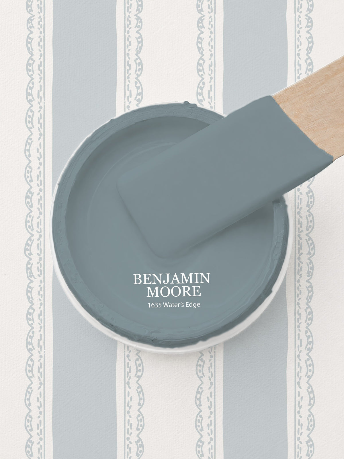 Light blue and white striped wallpaper with lace motifs and paint sample.