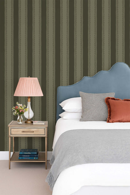 Lacey Stripes Green wallpaper with lace-edged vertical stripes in a cozy bedroom setting.