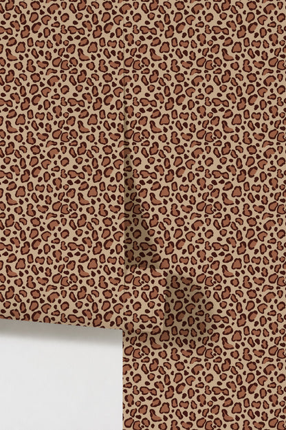Leopard print brown wallpaper with bold spots on beige background.