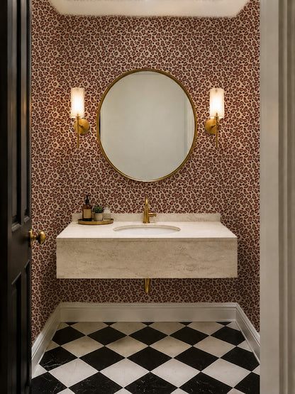 Leopard print brown wallpaper in modern bathroom with round mirror and sconces.