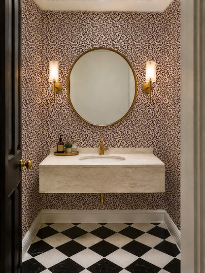 Leopard print cream wallpaper in a modern bathroom with checkered floor and round mirror.