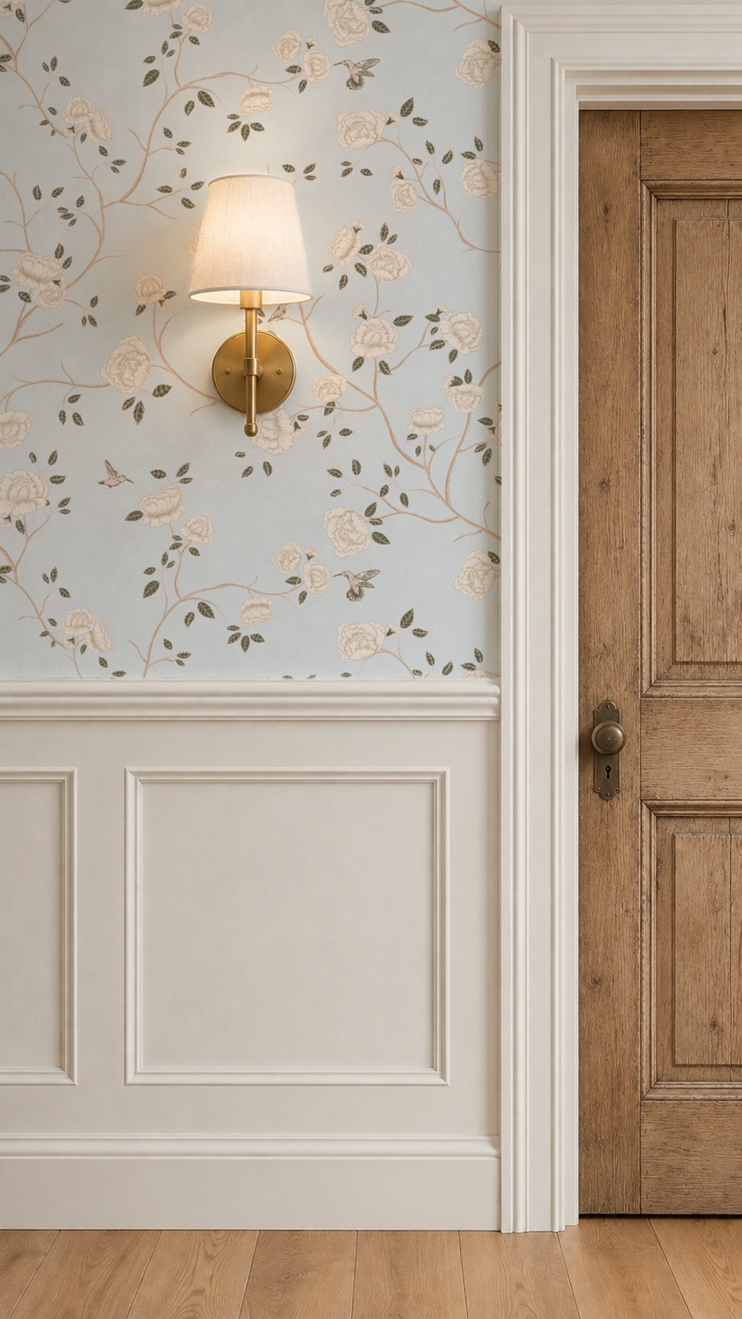 Light blue wallpaper with cream roses and hummingbirds in vintage style room.