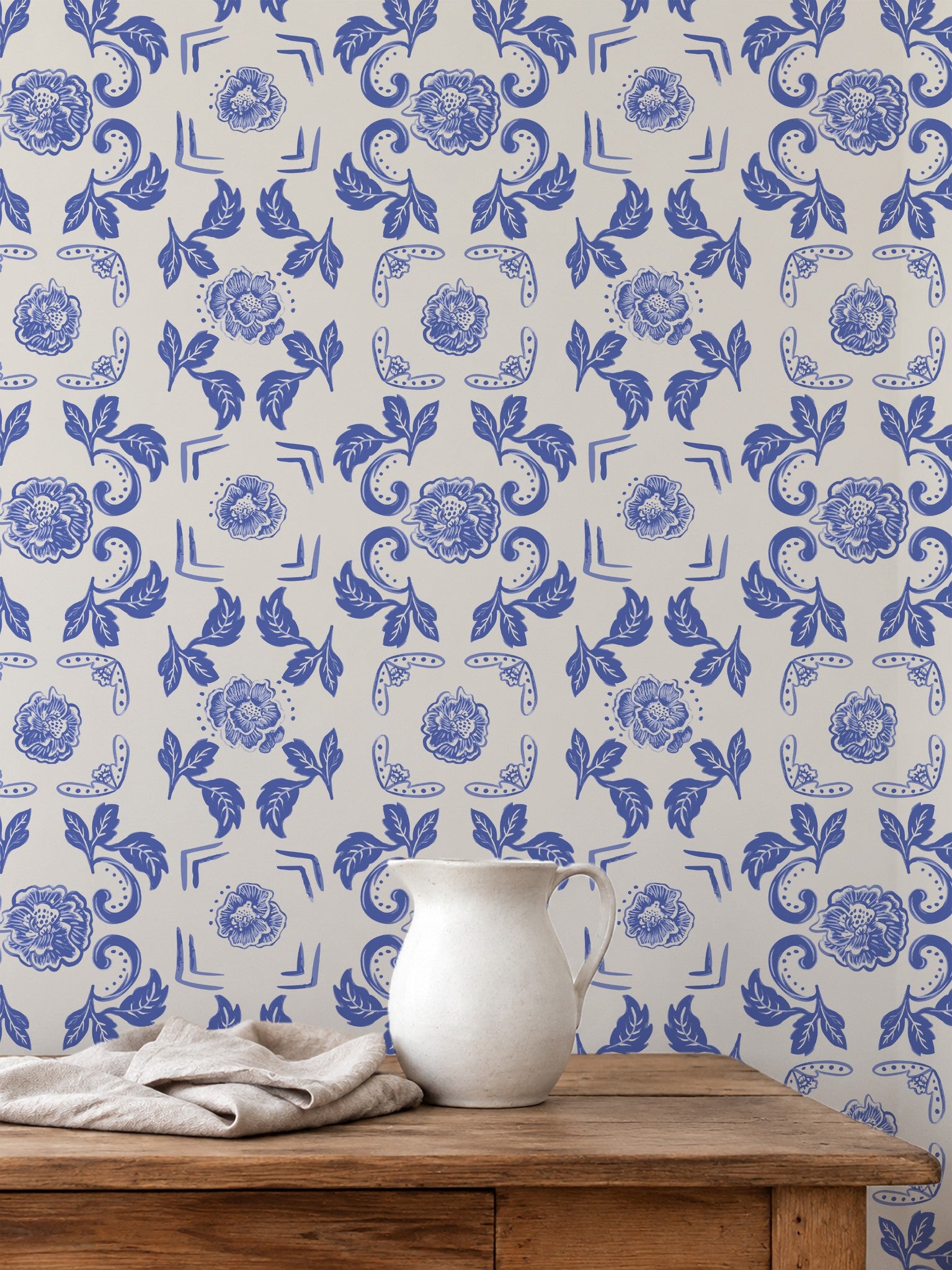 Nora Delft Blue wallpaper with intricate blue florals on cream in rustic room setting.