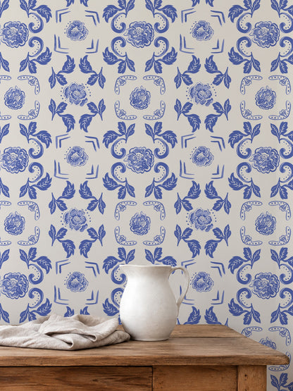 Nora Delft Blue wallpaper with intricate blue florals on cream in rustic room setting.