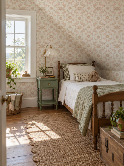 Nora Pink floral wallpaper in a vintage bedroom with wooden bed and green nightstand.