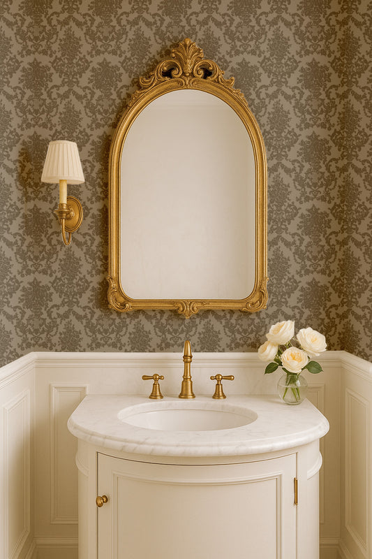Elegant bathroom with olive green damask wallpaper, gold mirror, and white sink.