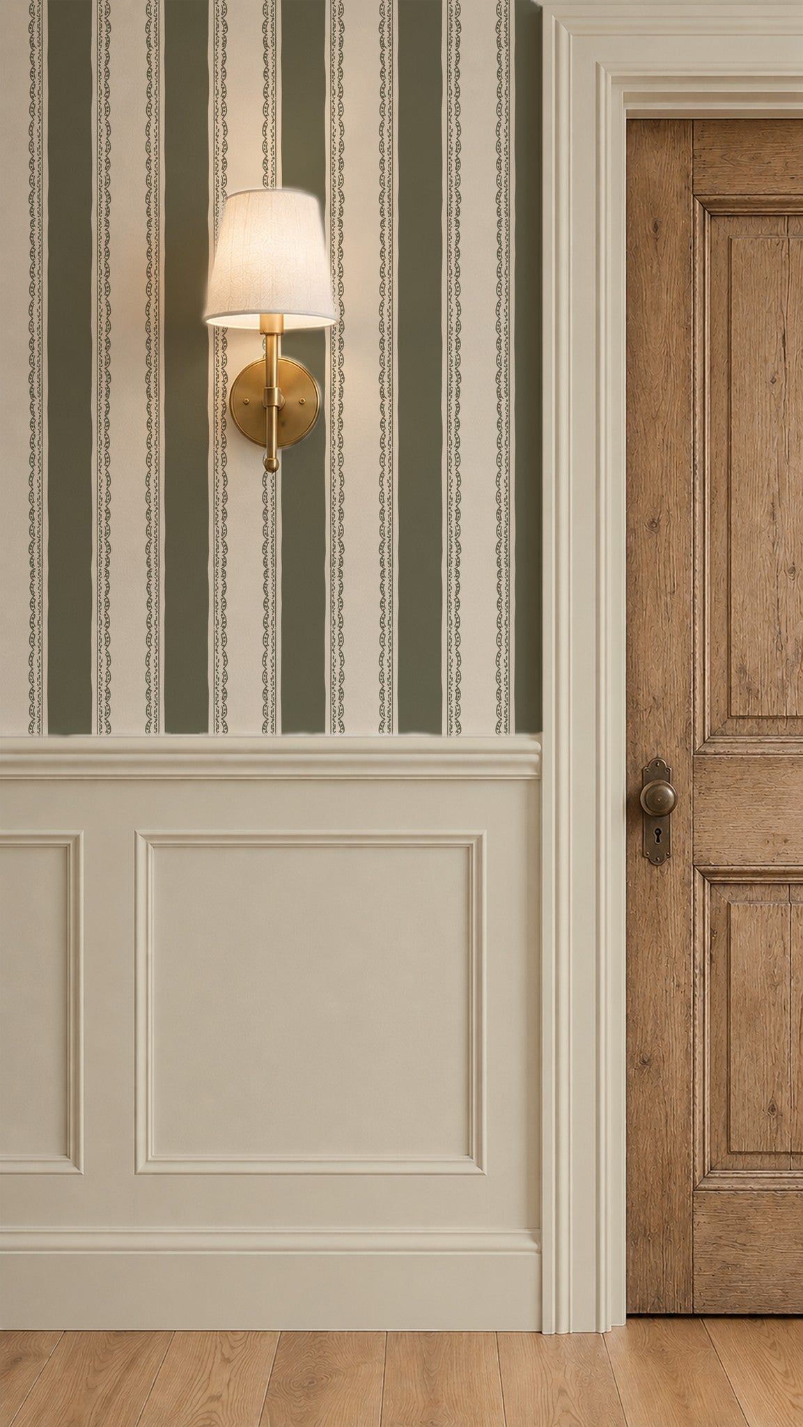 Olive green striped wallpaper with lace detail in elegant room with wood door.