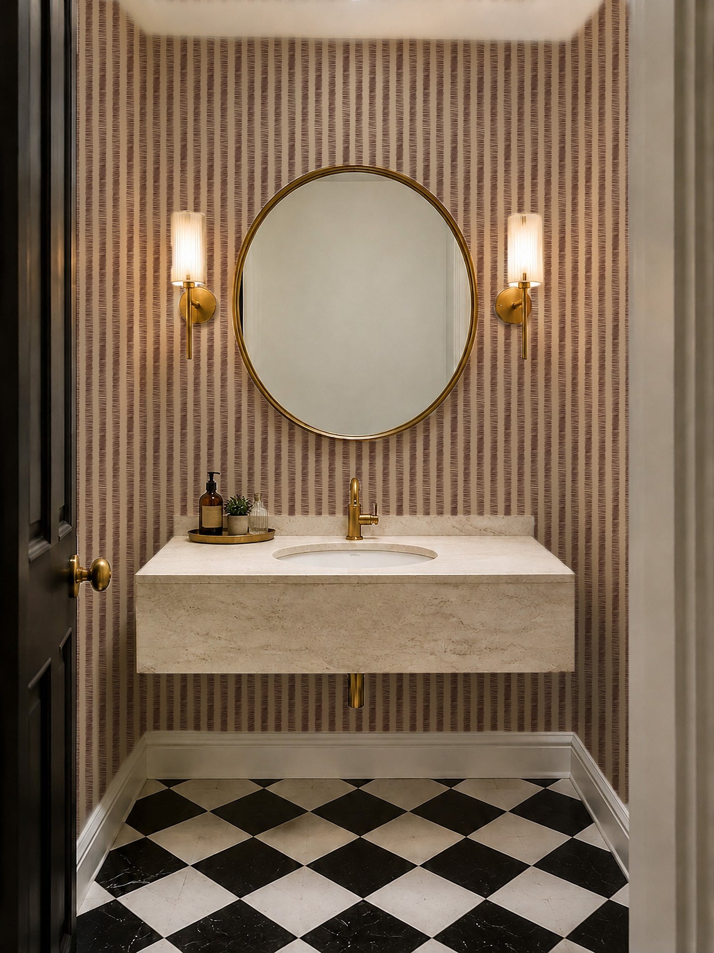 Bathroom with organic stripes red wallpaper, round mirror, and gold fixtures.