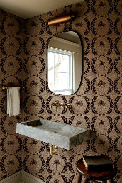 Palm wreath red wallpaper in bathroom with marble sink and oval mirror.