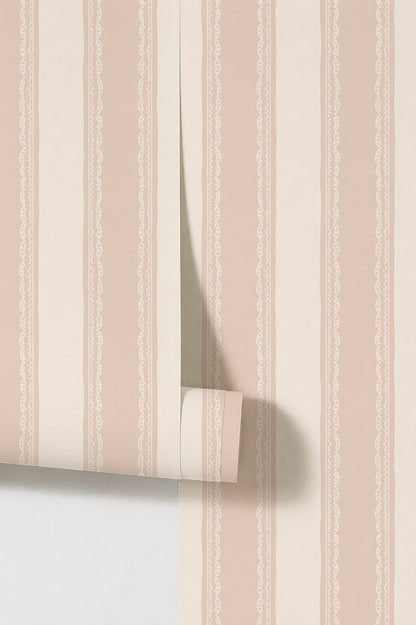 Pink and cream striped wallpaper with lace details in a vintage style.