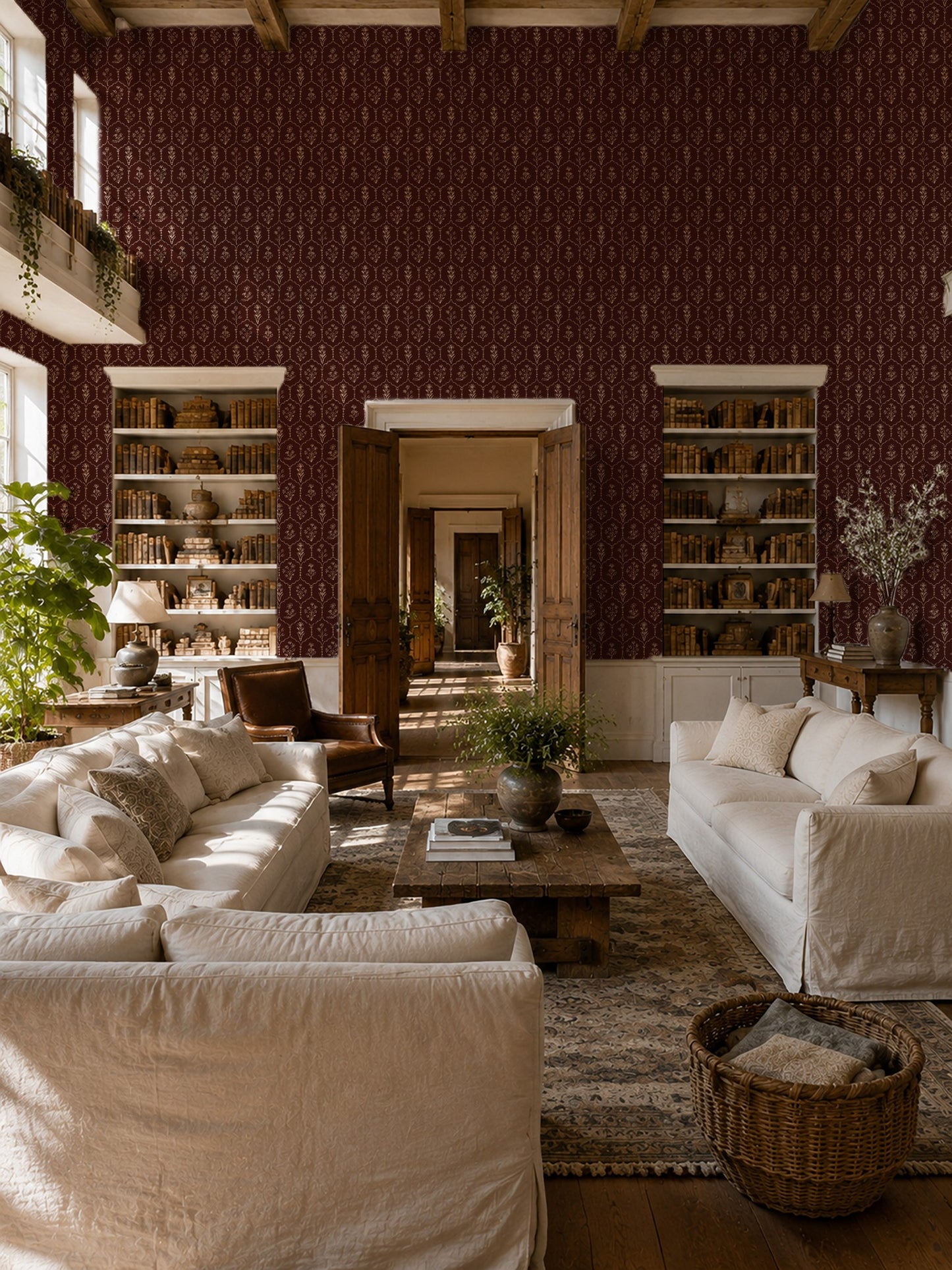 Living room with red floral trellis wallpaper, cream sofas, and wooden accents.