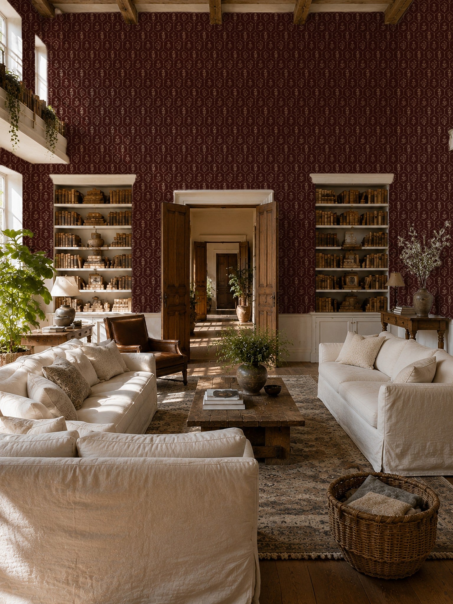 Living room with red floral trellis wallpaper, cream sofas, and wooden accents.
