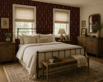 Bedroom with red floral trellis wallpaper and vintage decor.