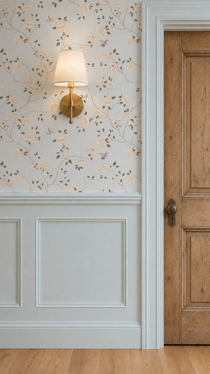 Light blue wallpaper with cream roses and hummingbirds in a classic room setting.