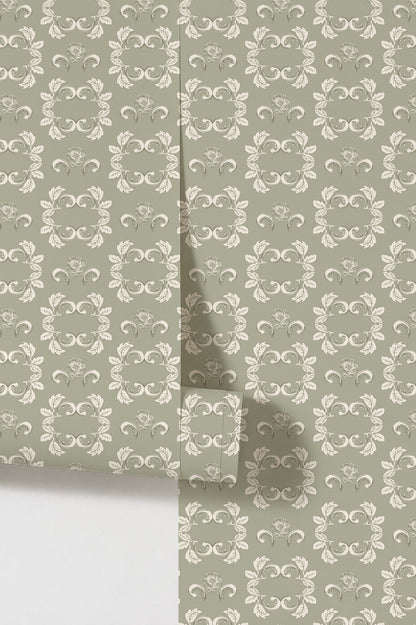 Sage green wallpaper with cream floral scrolls and intricate motifs.