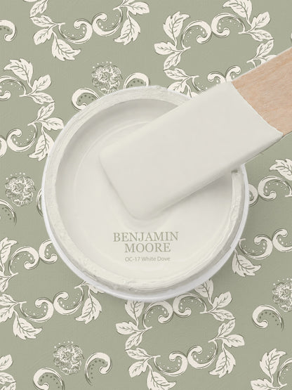 Sage green wallpaper with cream floral scrolls and paint swatch.